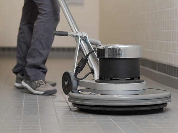 Commercial cleaning crew polishing a floor